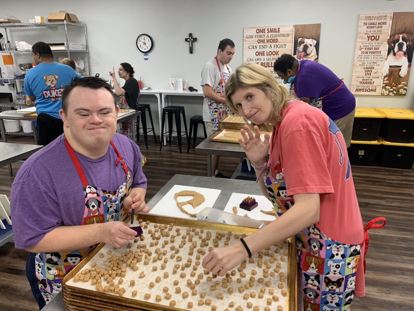 Two people enjoy playing a game with wooden pieces at a table.