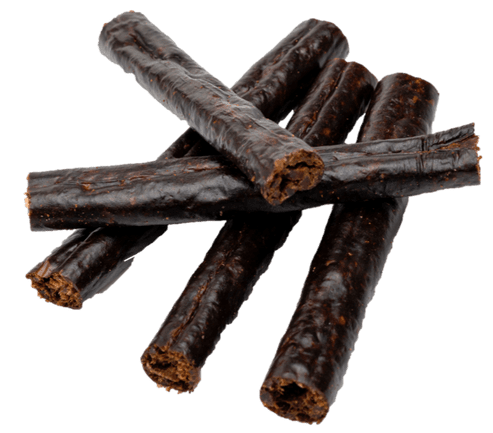 Close-up of licorice sticks arranged in a pile.
